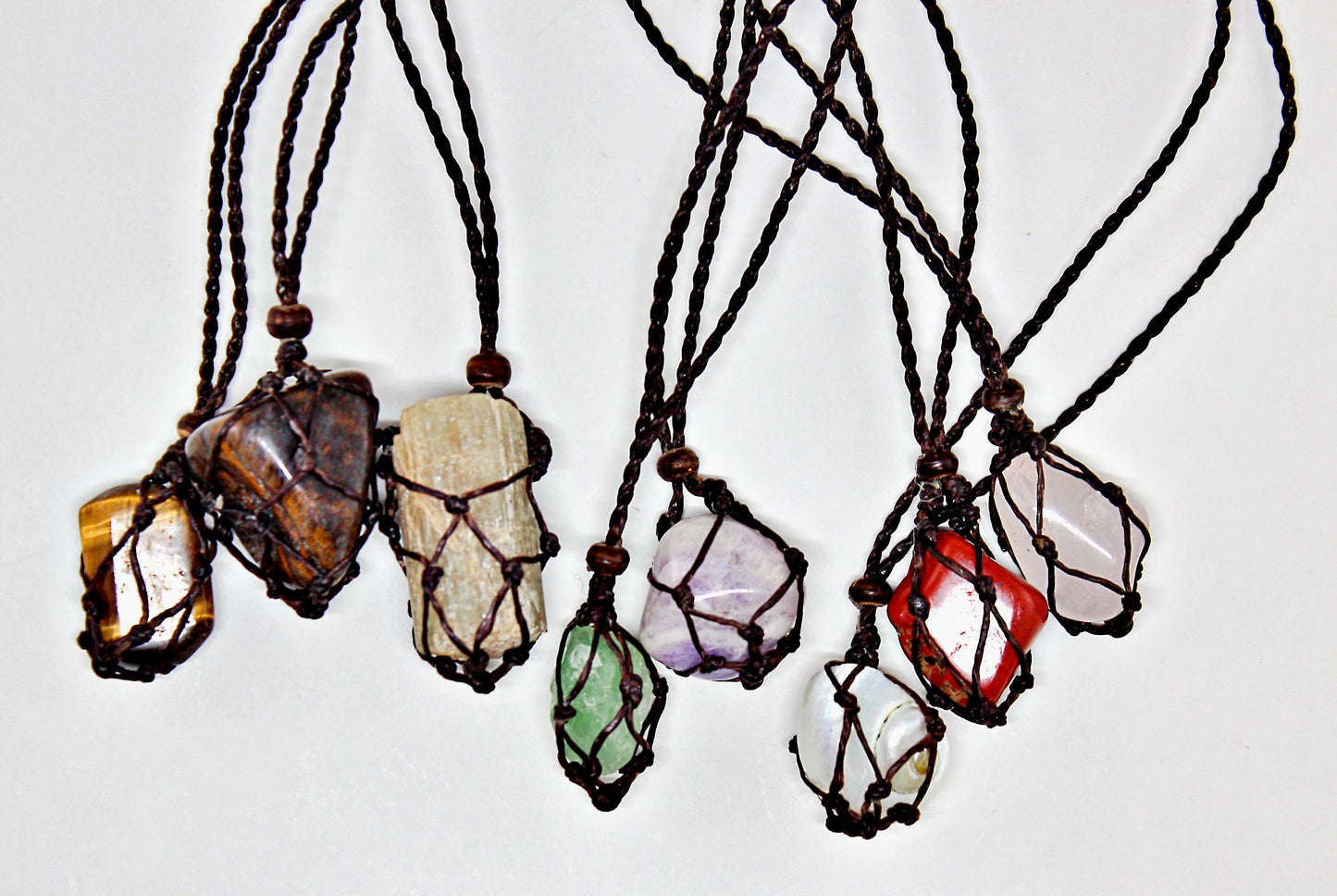 Handmade interchangeable macramé cage necklaces with tumbled stone